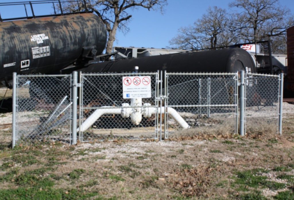 pipeline behind chain link structure